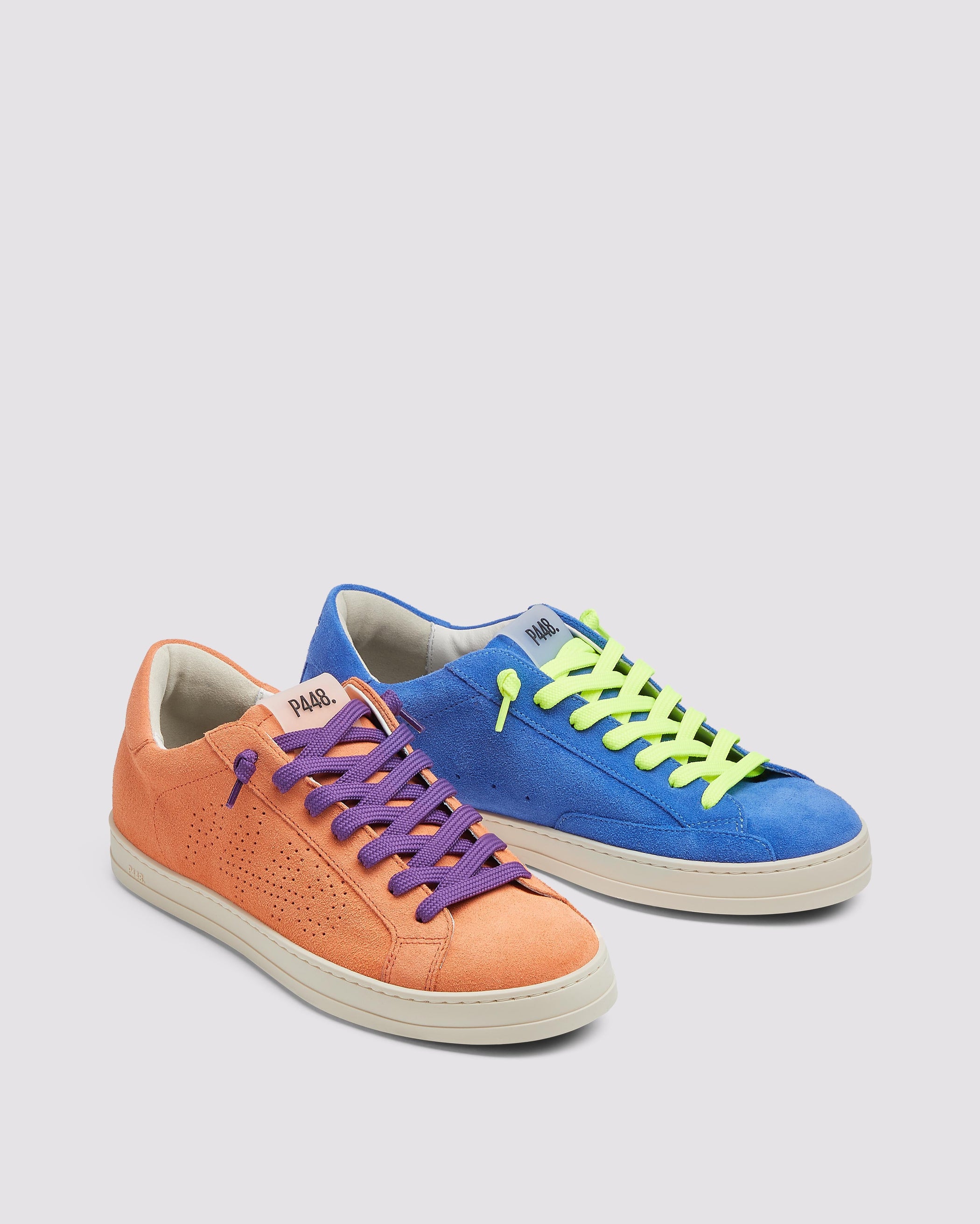 Side angle of the left blue sneaker with yellow laces and right orange sneaker with purple laces