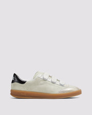 Side angle of beige and gold sneakers