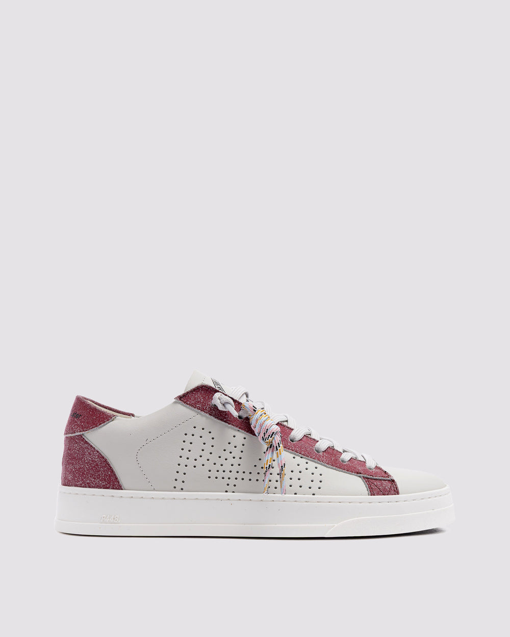 Side angle of white and pink sneakers
