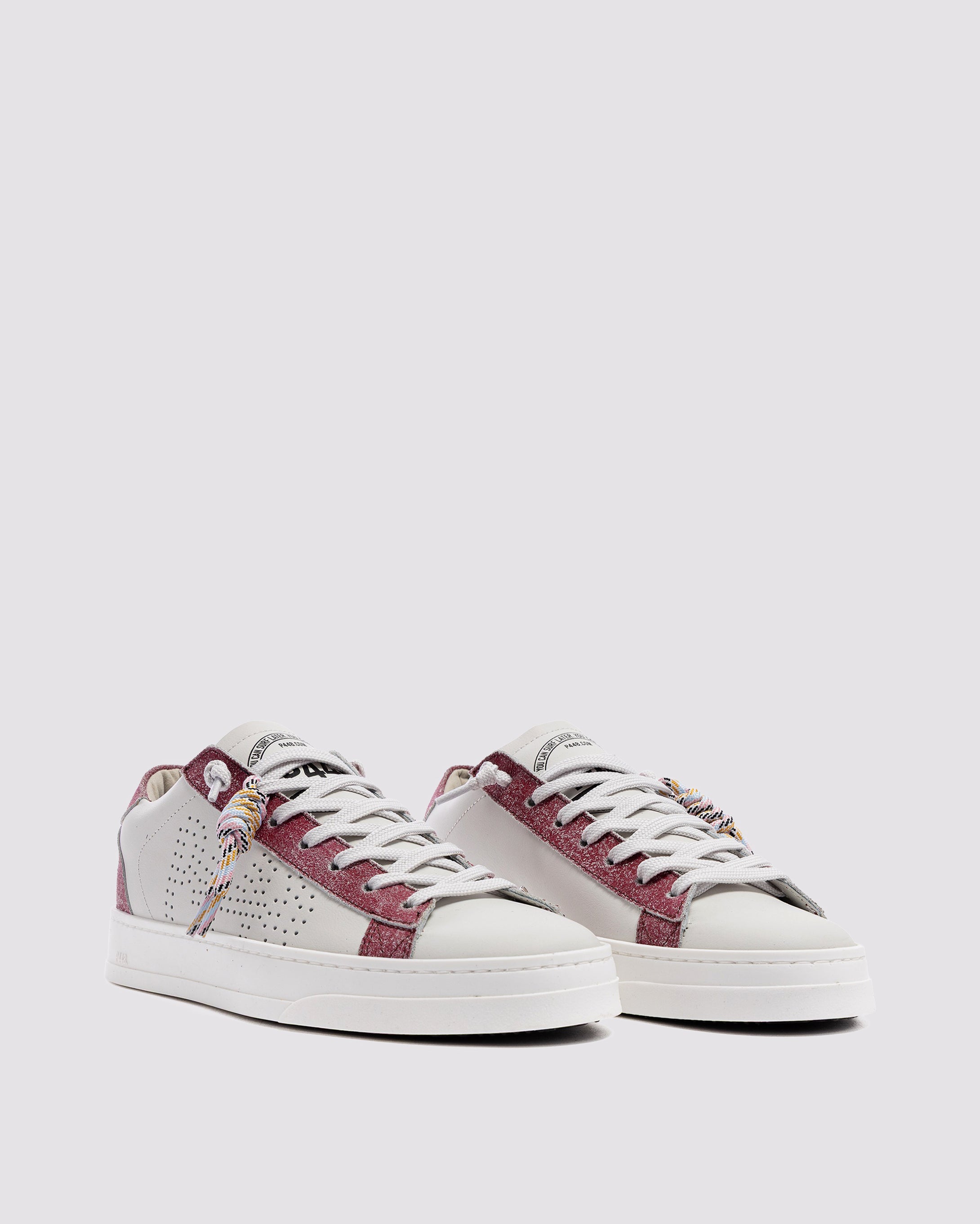 Side angle of white and pink sneakers