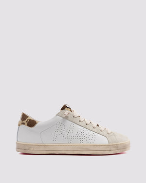 Side angle of white and brown cow print sneakers