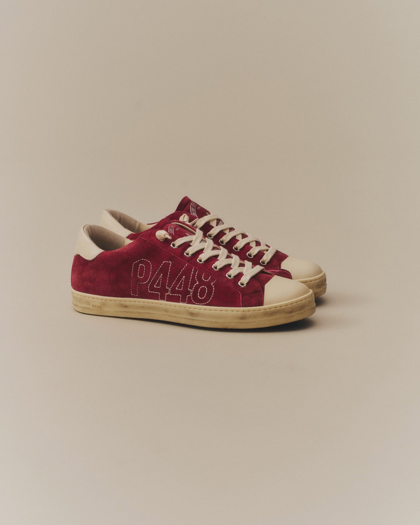 Front angle of burgundy sneakers