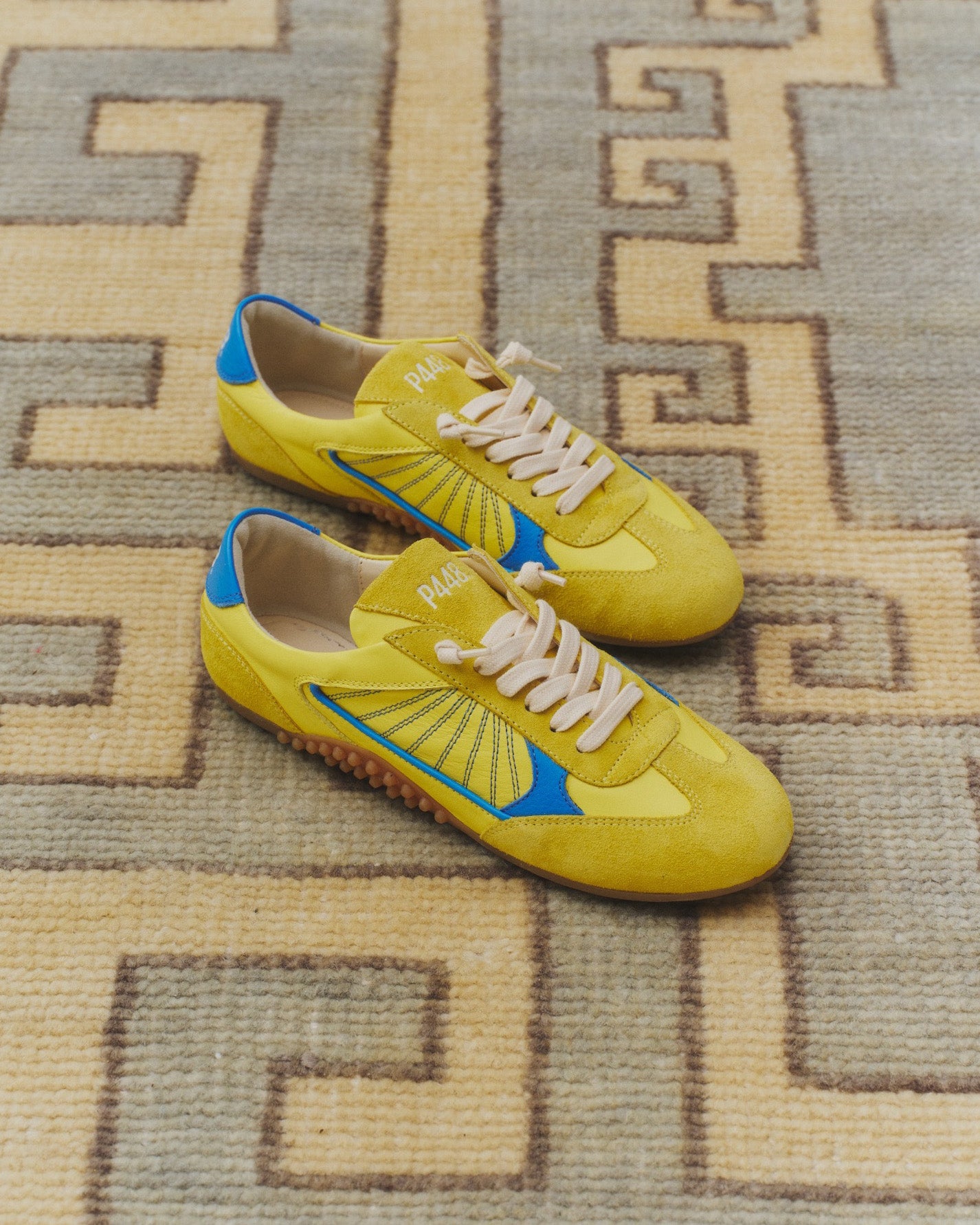 Side angle of yellow and blue sneakers